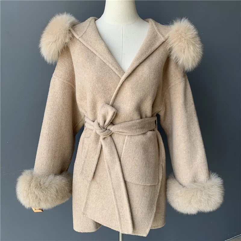Beige coat with fur trim on a mannequin against a dark background