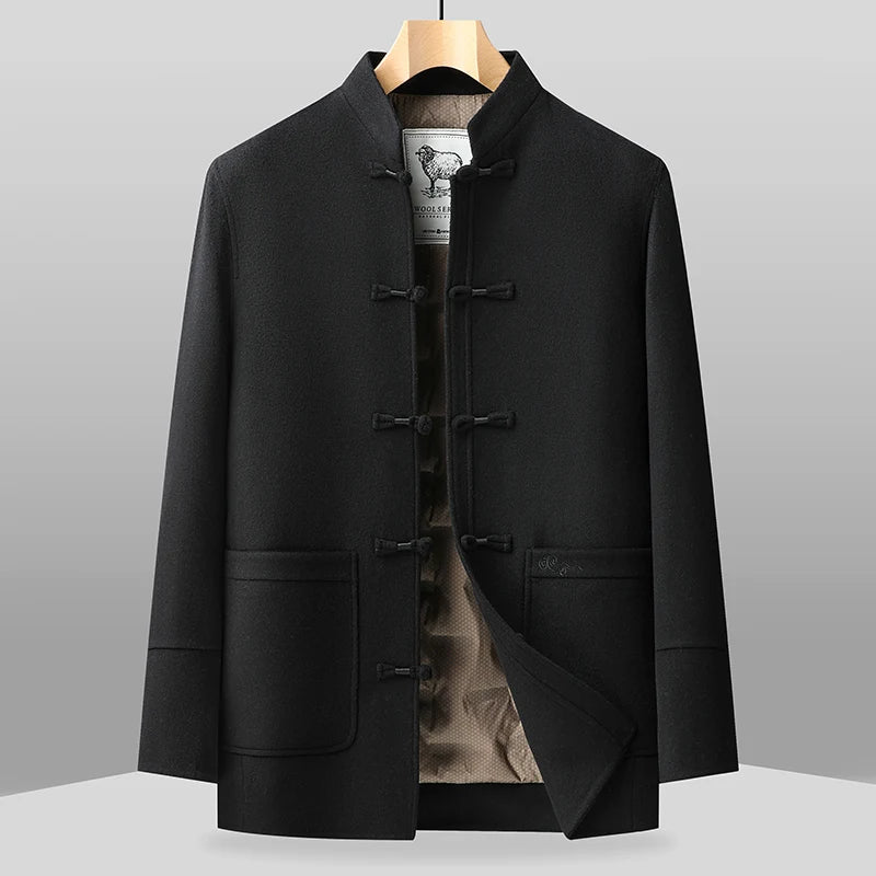 Black traditional-style jacket on a hanger against a gray background