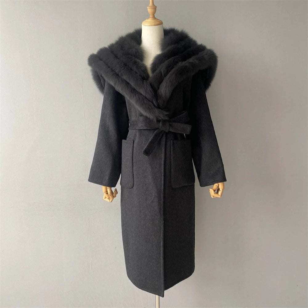 Gray coat with fur collar on a mannequin against a plain background