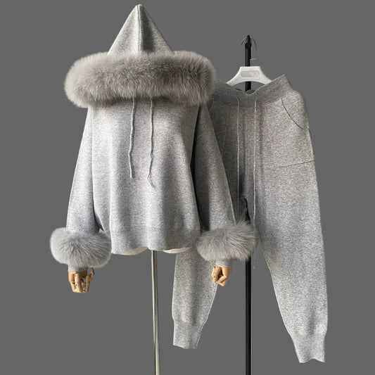 Gray hoodie with fur trim on a mannequin against a plain background