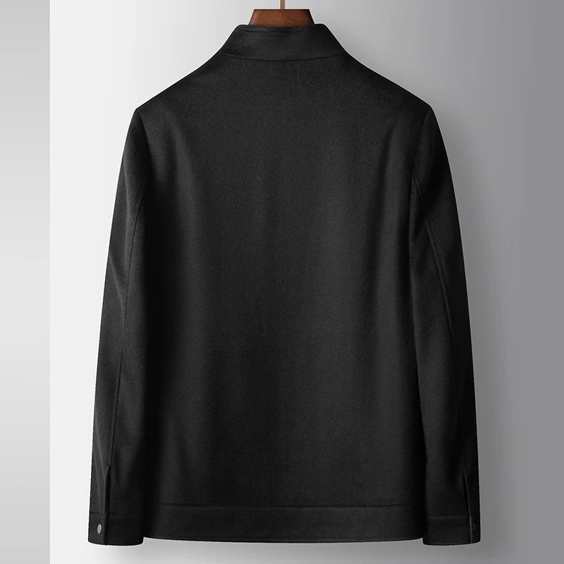 Black jacket on a mannequin against a gray background