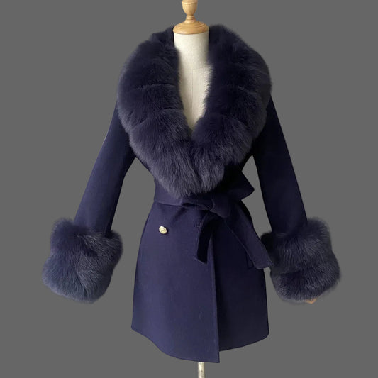 Navy blue coat with fur accents on a mannequin against a plain background