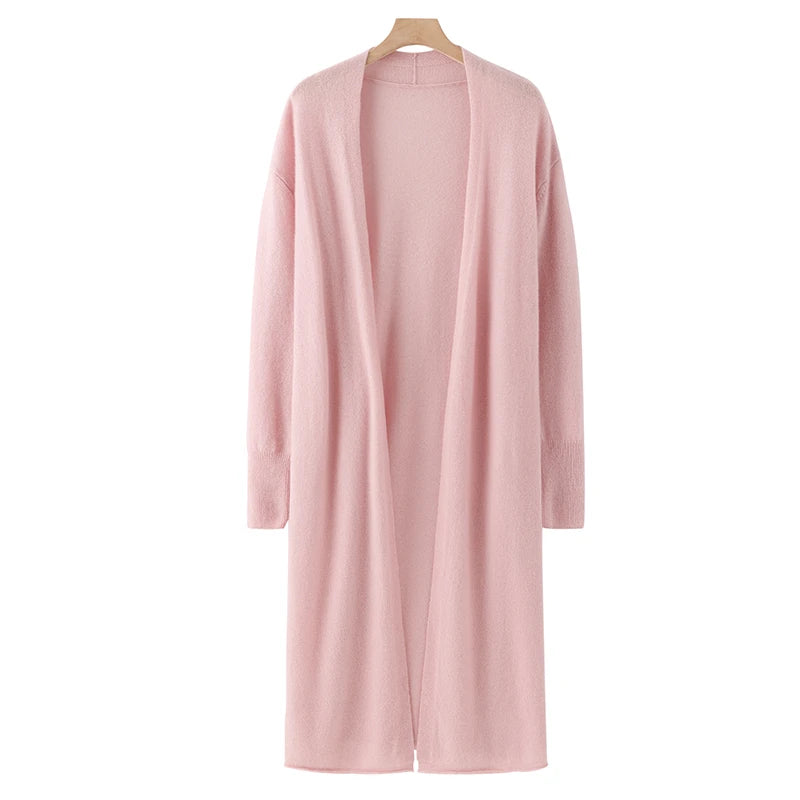 Pink cardigan on a hanger against a white background