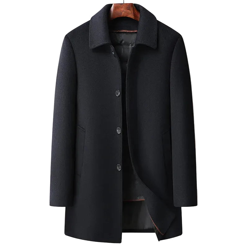 Black coat on a hanger against a beige background