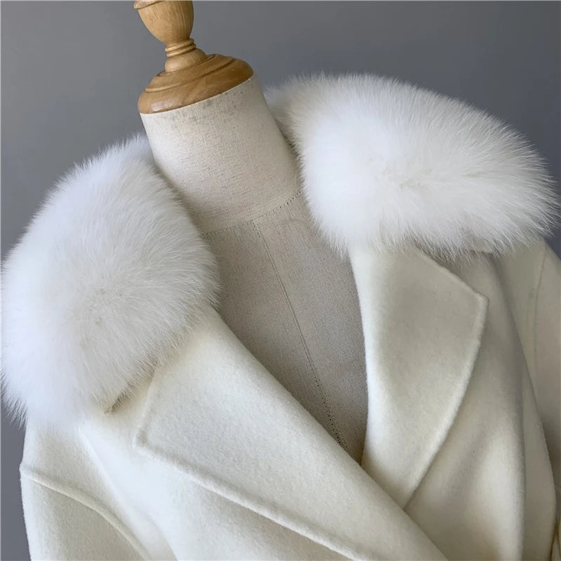 White coat with fur collar on a mannequin against a gray background