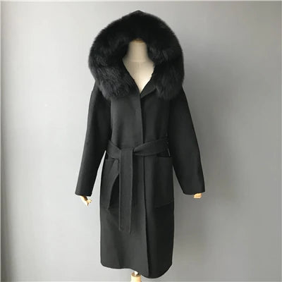 Black coat with fur hood on a mannequin against a gray background