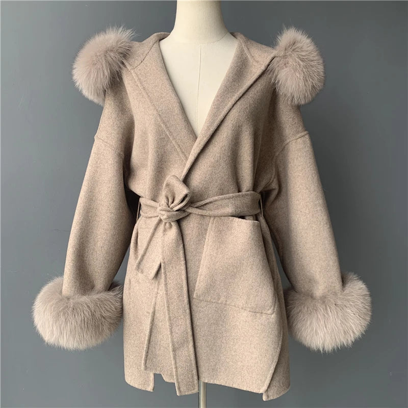 Beige coat with fur trim on a mannequin against a gray background