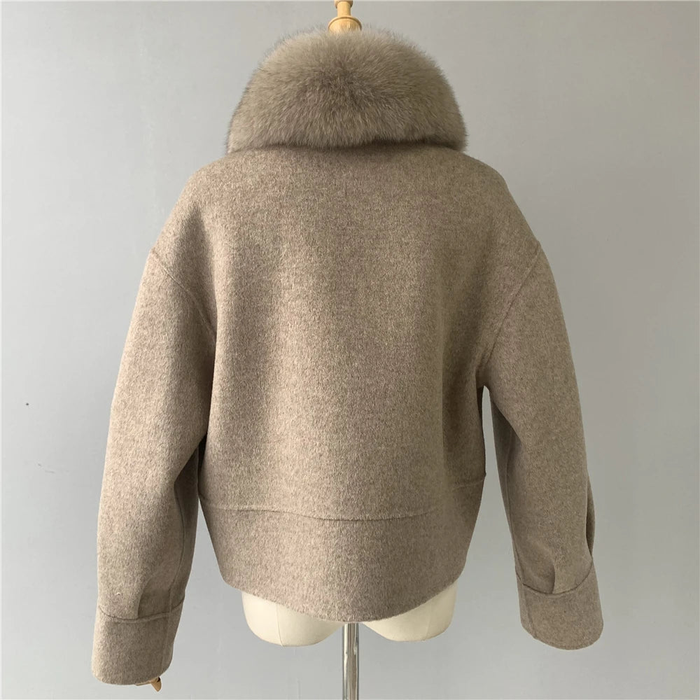 Beige jacket with fur collar on a mannequin against a gray background
