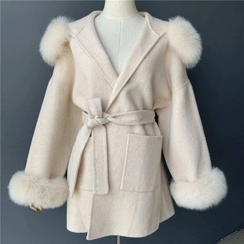 Beige coat with fur trim on a mannequin against a dark background