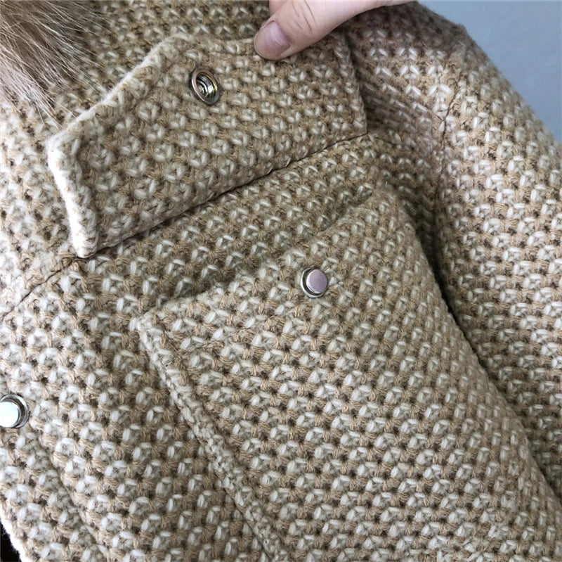 Close-up of a textured fabric with buttons on a garment.