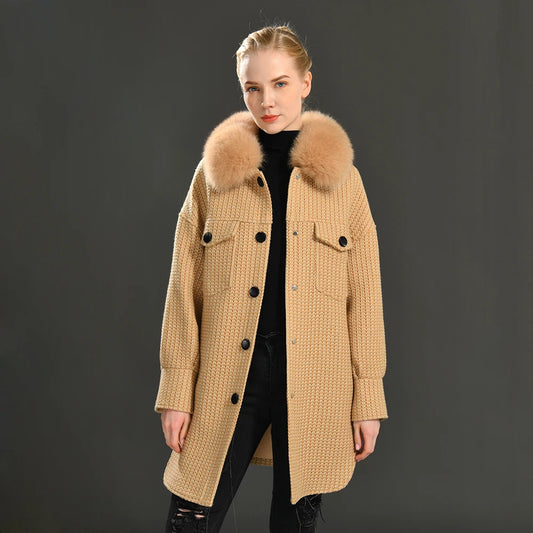 Woman wearing a beige coat with fur collar on a dark background