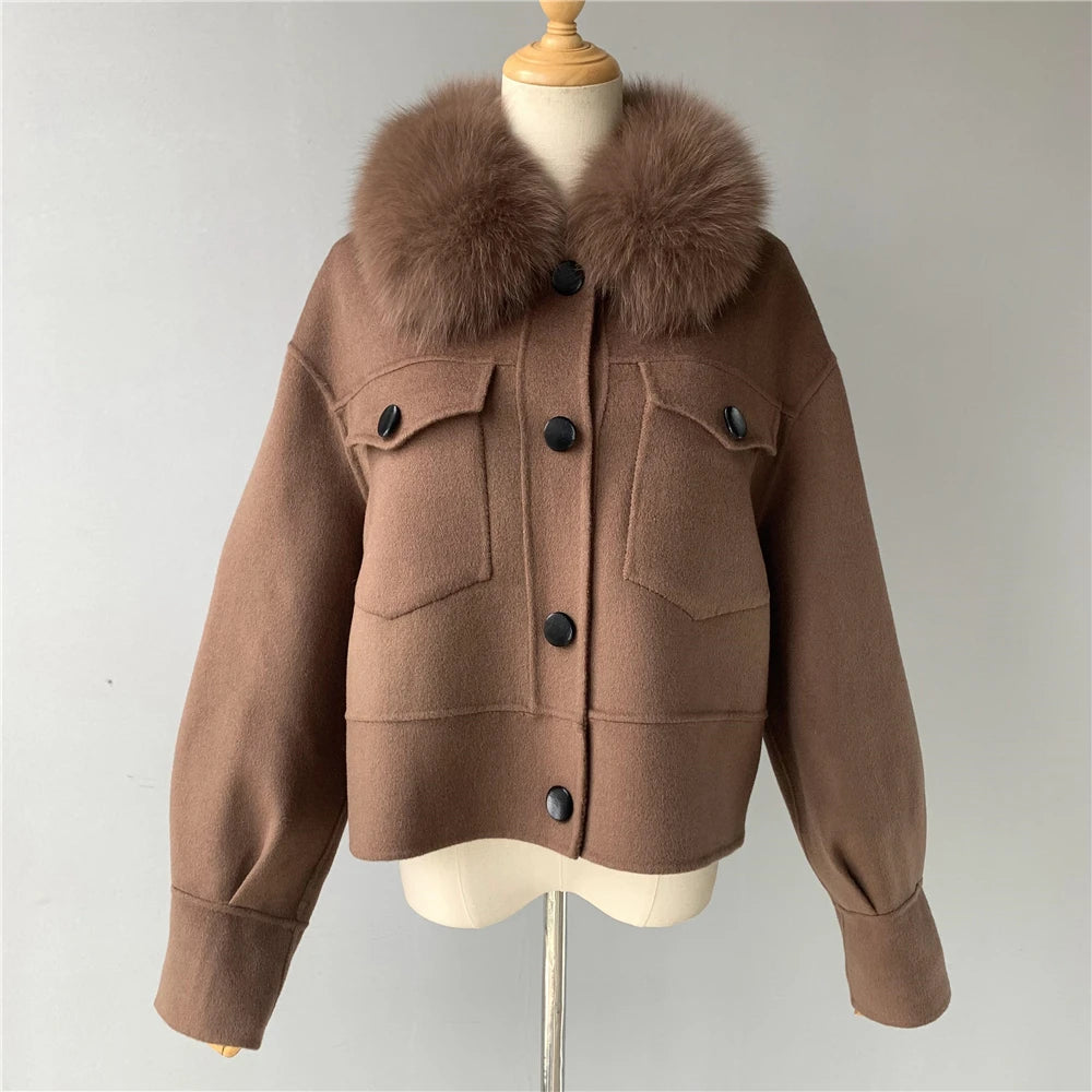 Brown jacket with fur collar on a mannequin against a plain background