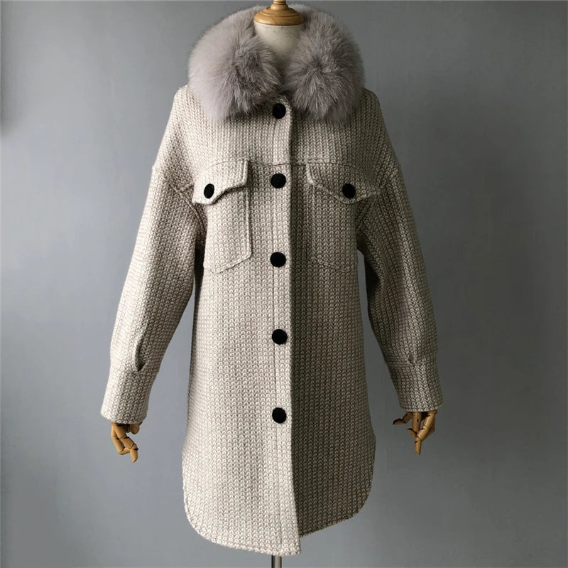Beige coat with fur collar on a mannequin against a gray background