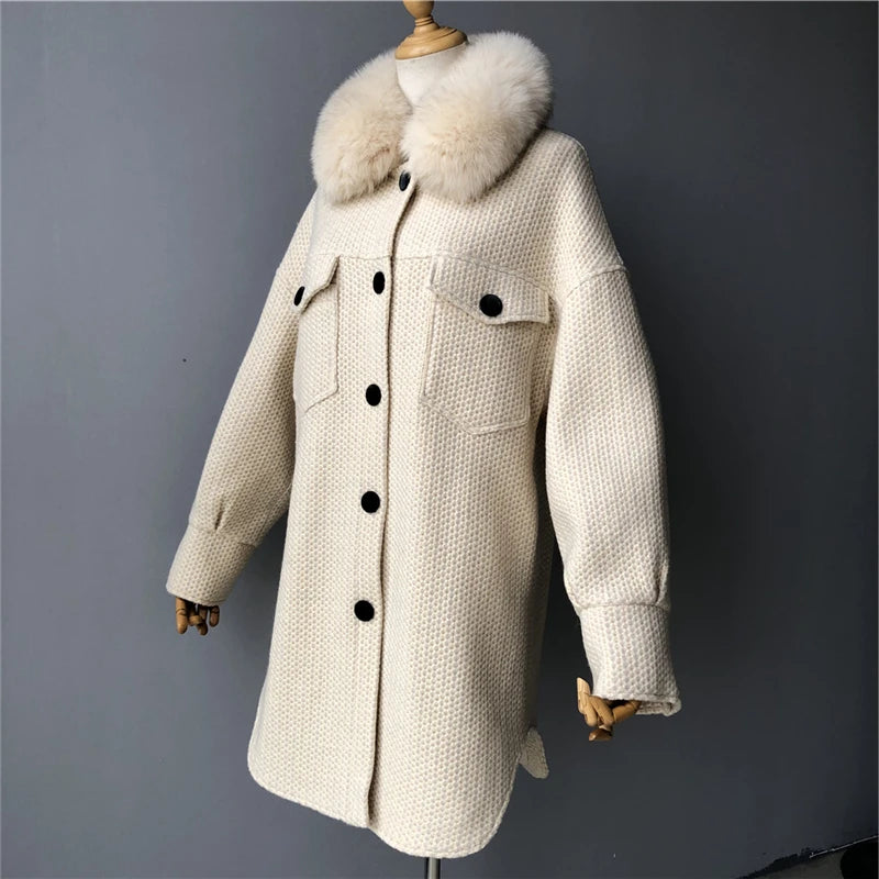 Beige coat with fur collar on a mannequin against a gray background