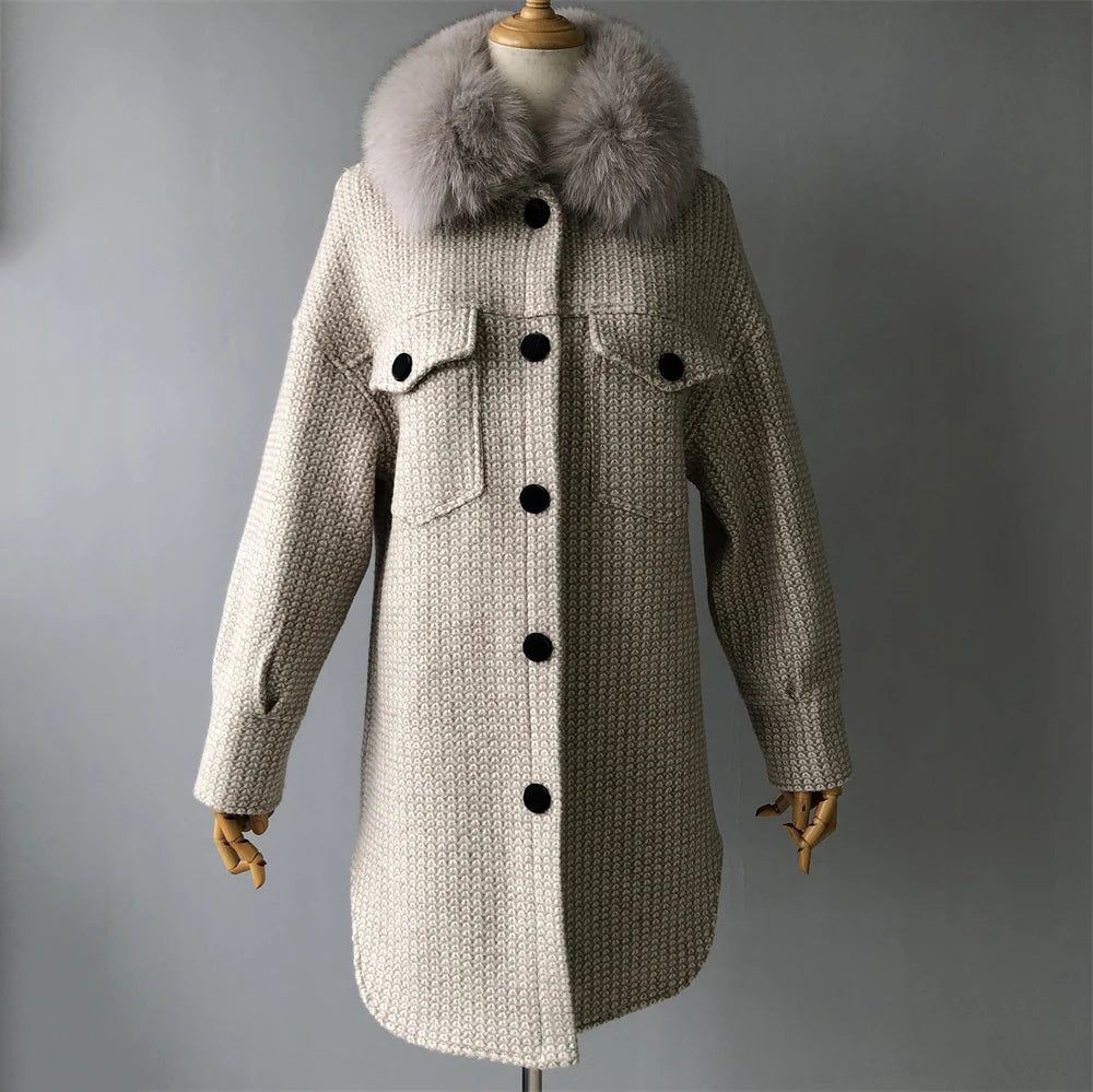 Beige coat with fur collar on a mannequin against a gray background