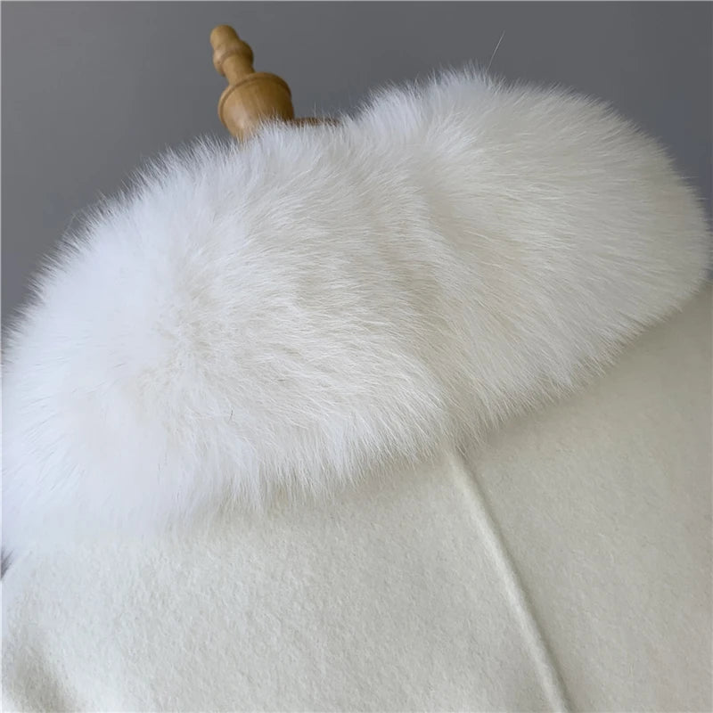 White fur stole draped over a garment on a wooden hanger against a neutral background