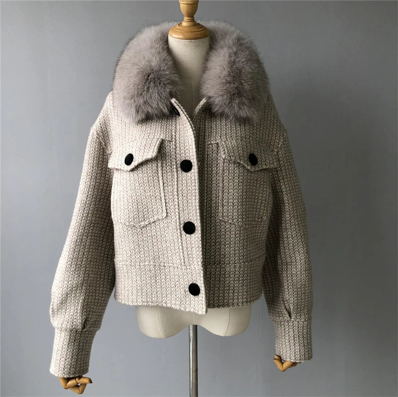 Knitted jacket with fur collar on a mannequin against a gray background