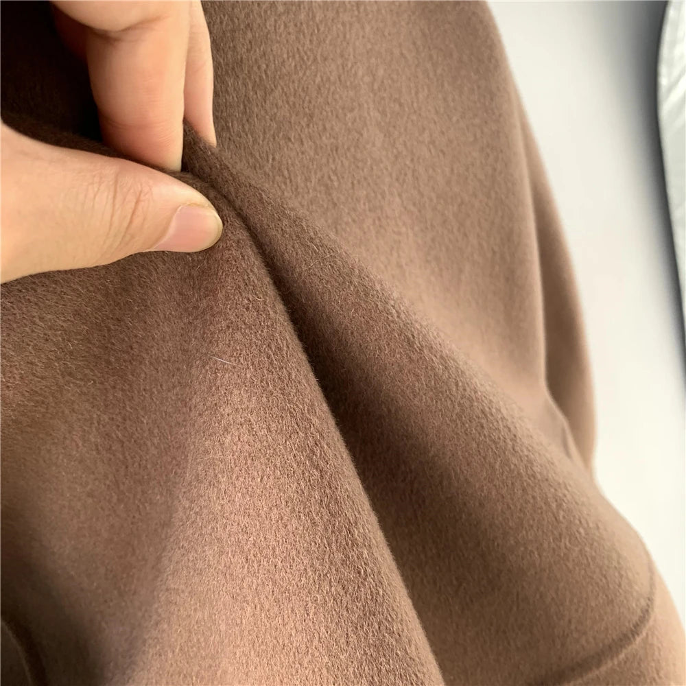 Close-up of brown fabric with a hand touching it