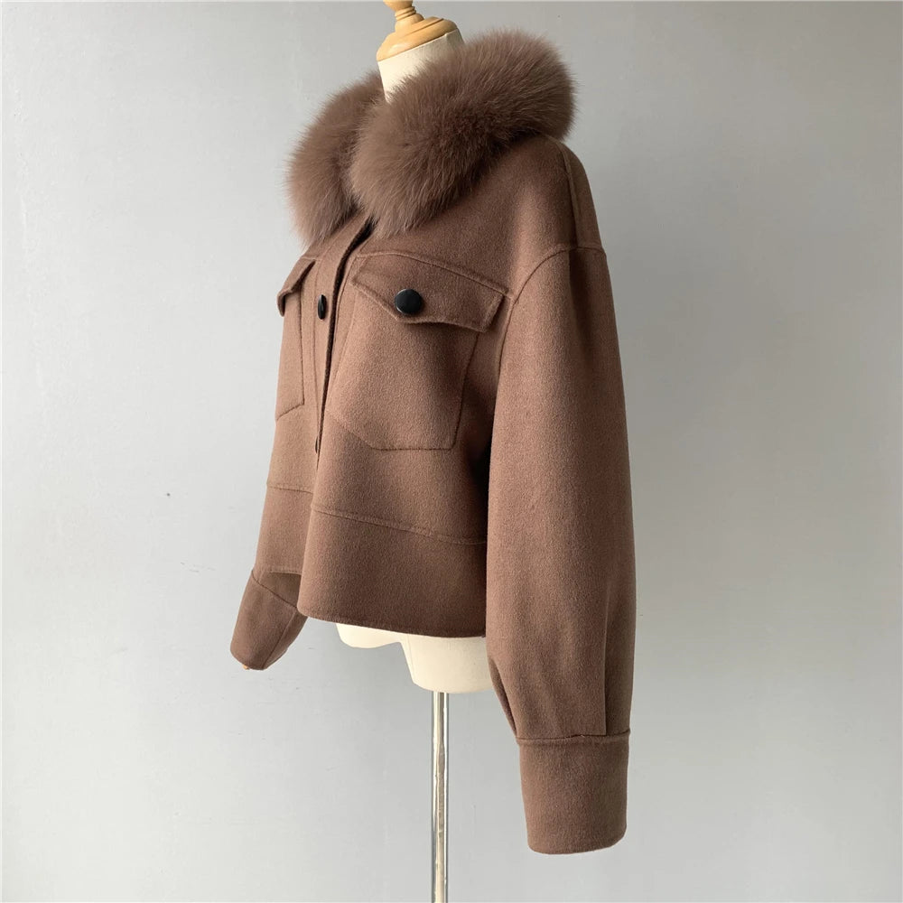 Brown coat with fur hood on a mannequin against a plain background