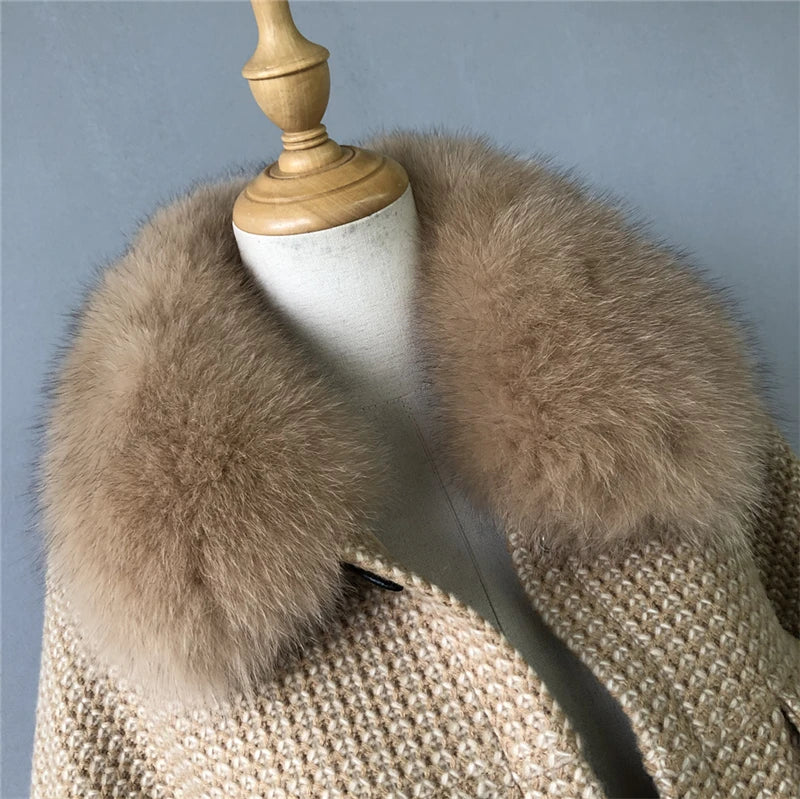 Mannequin wearing a beige coat with a fur collar against a gray background