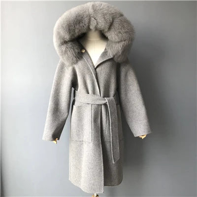 Gray coat with fur hood on a mannequin against a gray background