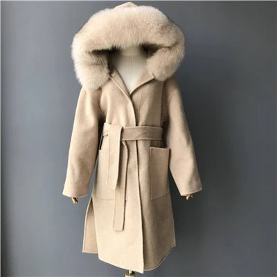 Beige coat with fur hood on a mannequin against a gray background