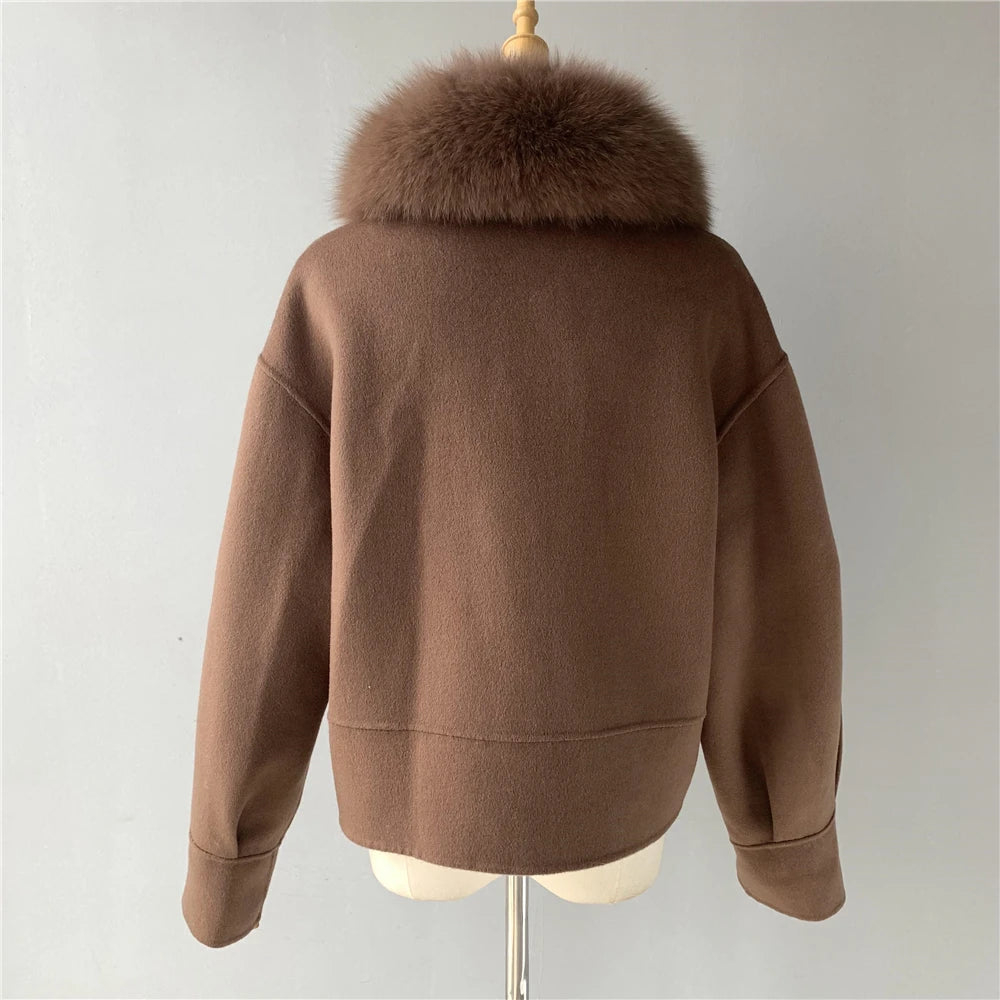 Brown jacket with fur collar on a mannequin against a plain background