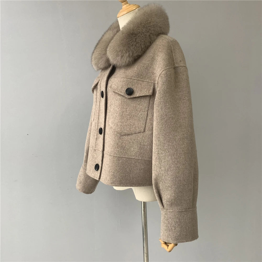 Beige coat with fur collar on a mannequin against a gray background