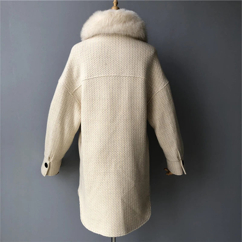 Beige coat with fur collar on a mannequin against a gray background
