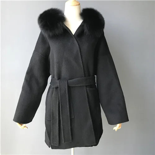Black coat with fur collar on a mannequin against a gray background