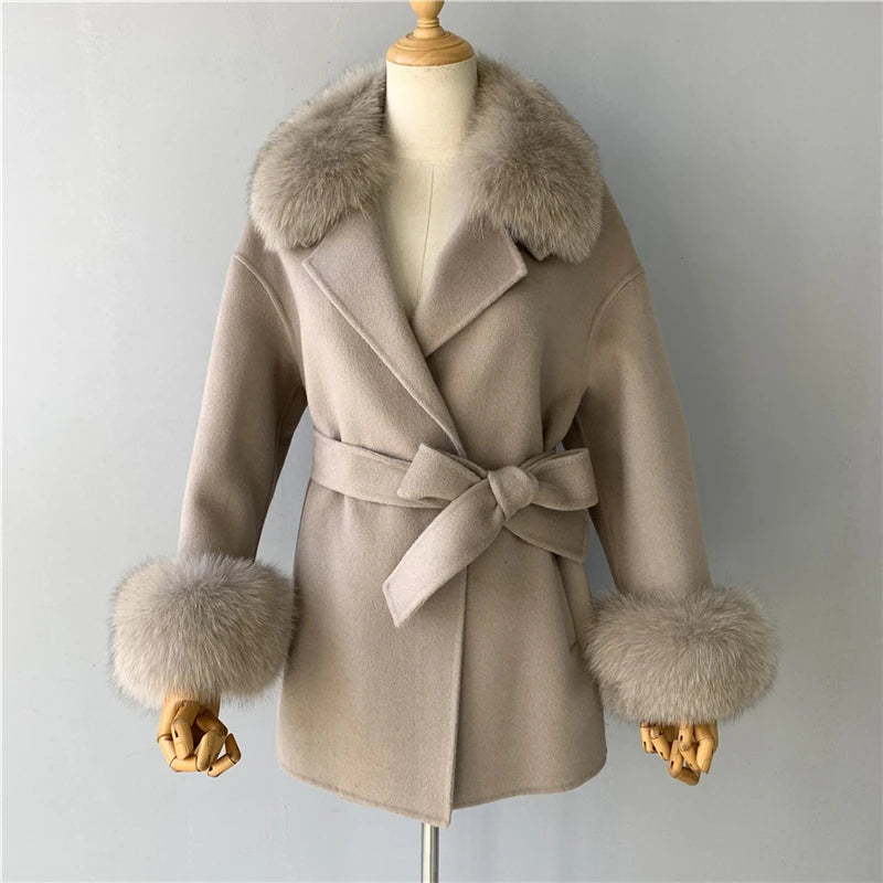 Beige coat with fur trim on a mannequin against a gray background
