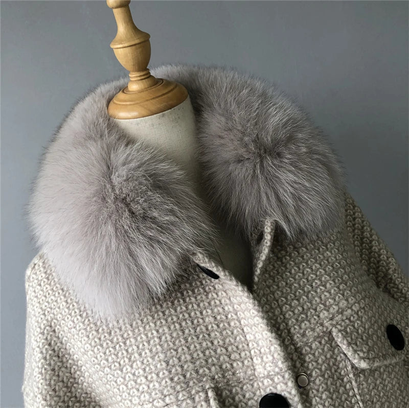 Gray fur scarf on a mannequin with a gray background