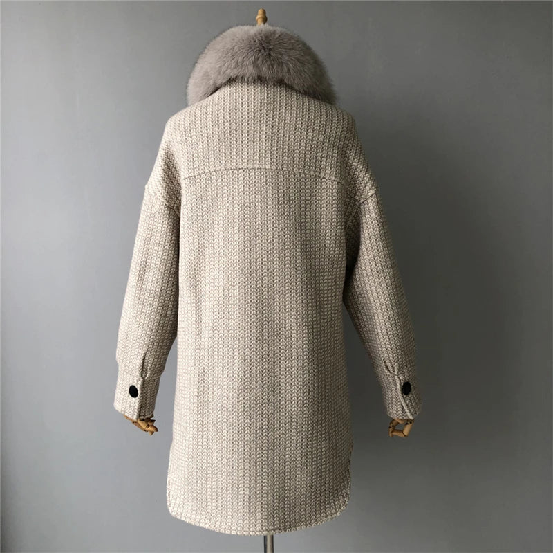 Beige winter coat with fur hood on a mannequin against a gray background