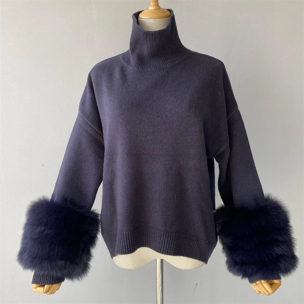 Navy sweater with fur cuffs on a mannequin against a plain background