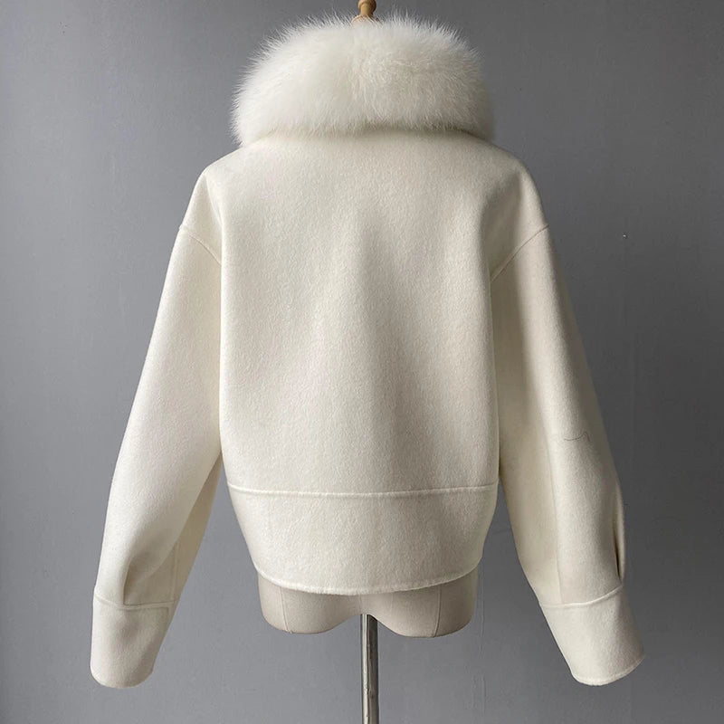 White jacket with fur collar on a mannequin against a gray background