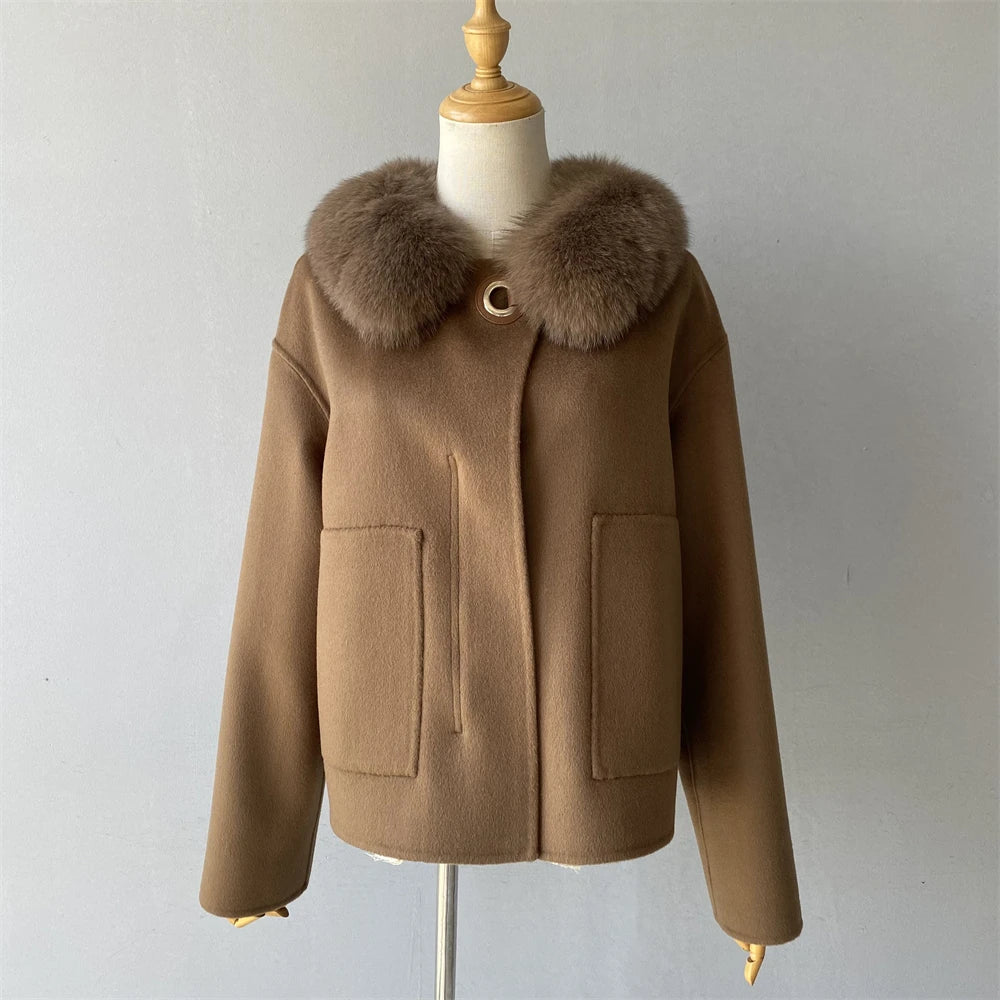 Brown coat with fur collar on a mannequin against a plain background