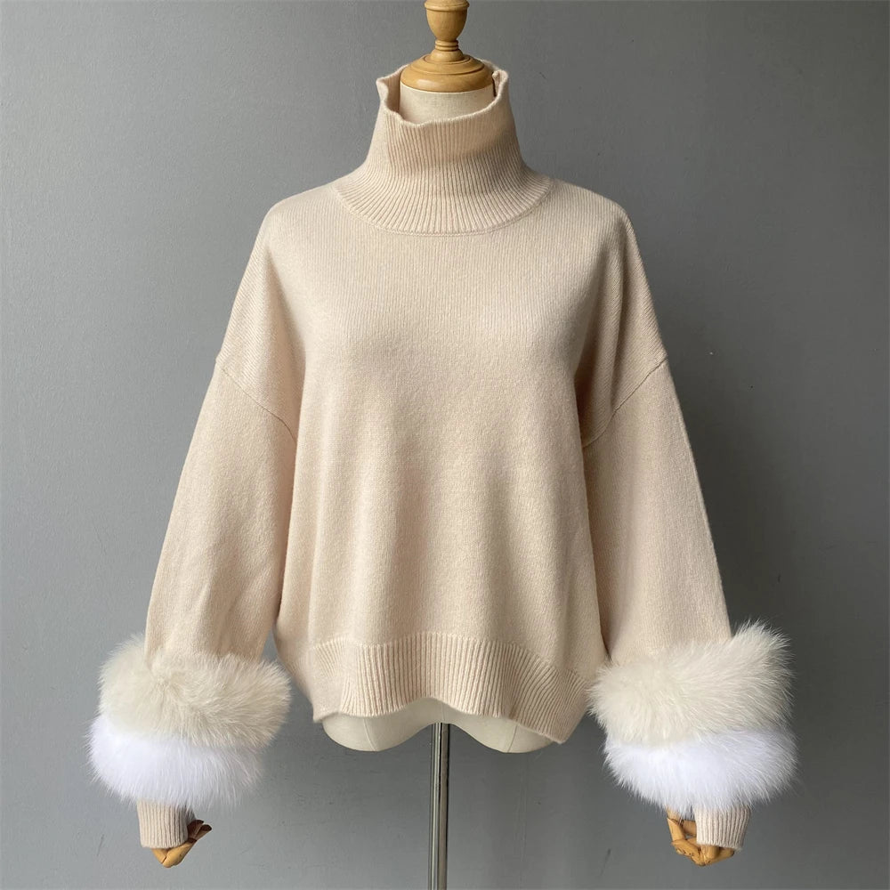 Beige sweater with fur cuffs on a mannequin against a gray background