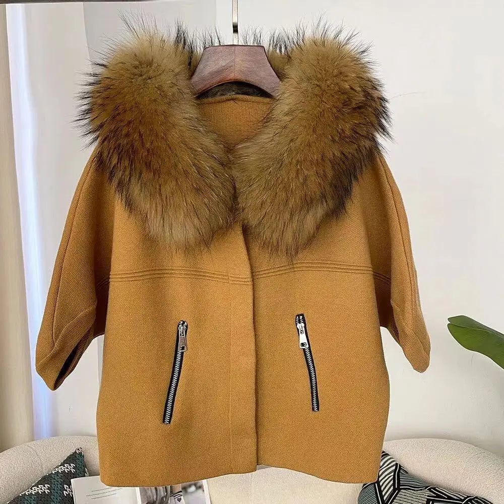 Brown coat with fur hood on a hanger against a white background