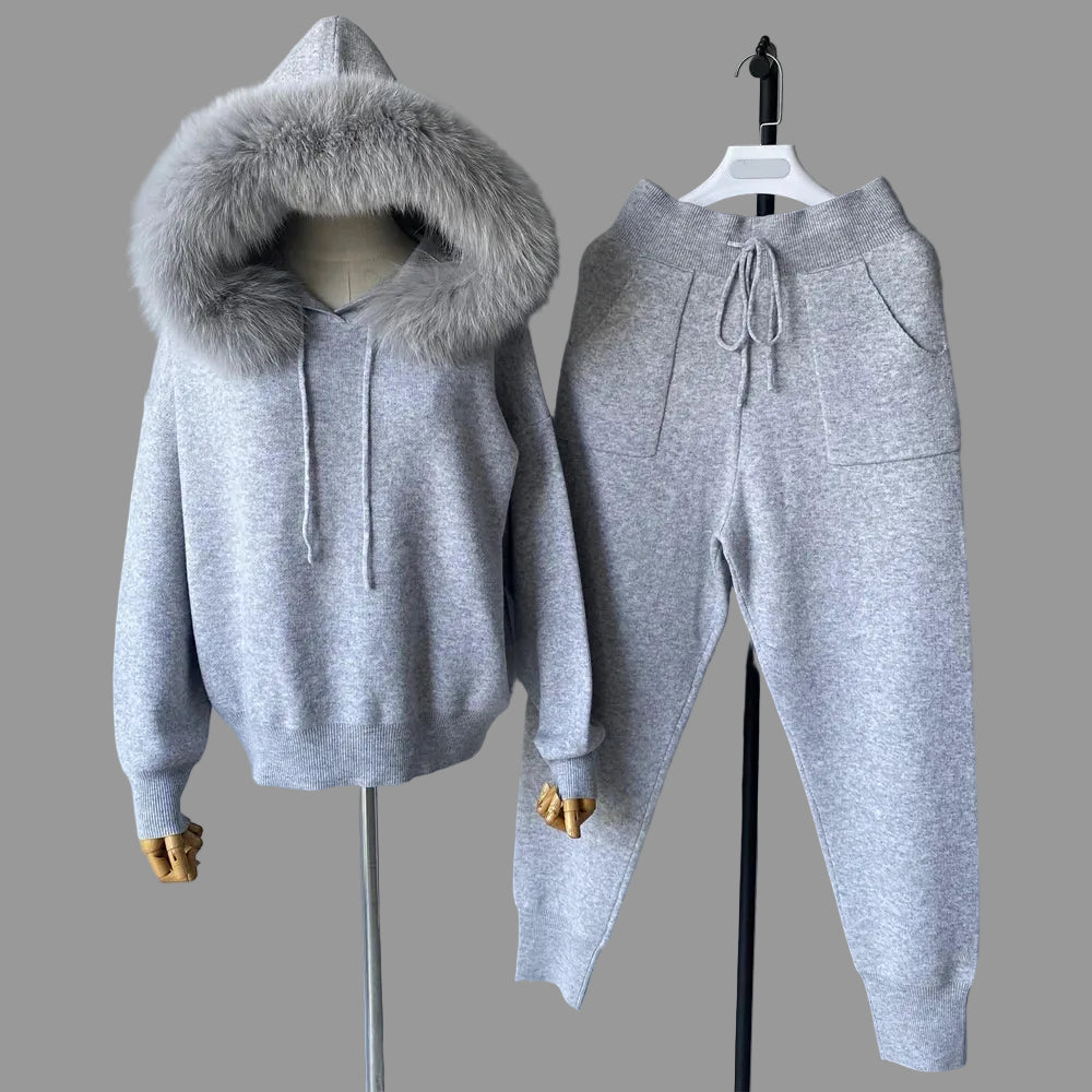 Gray hoodie with fur hood and matching pants on a gray background
