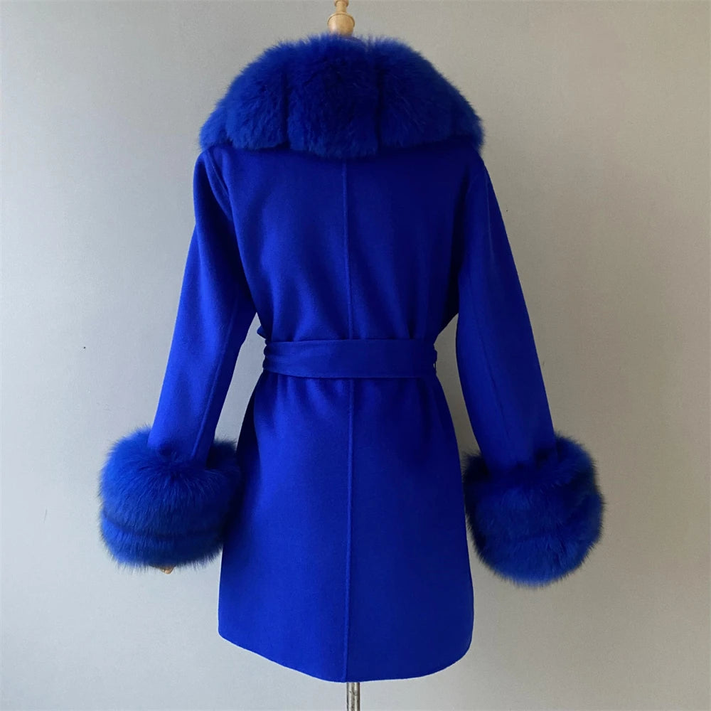 Blue coat with fur trim on a mannequin against a plain background