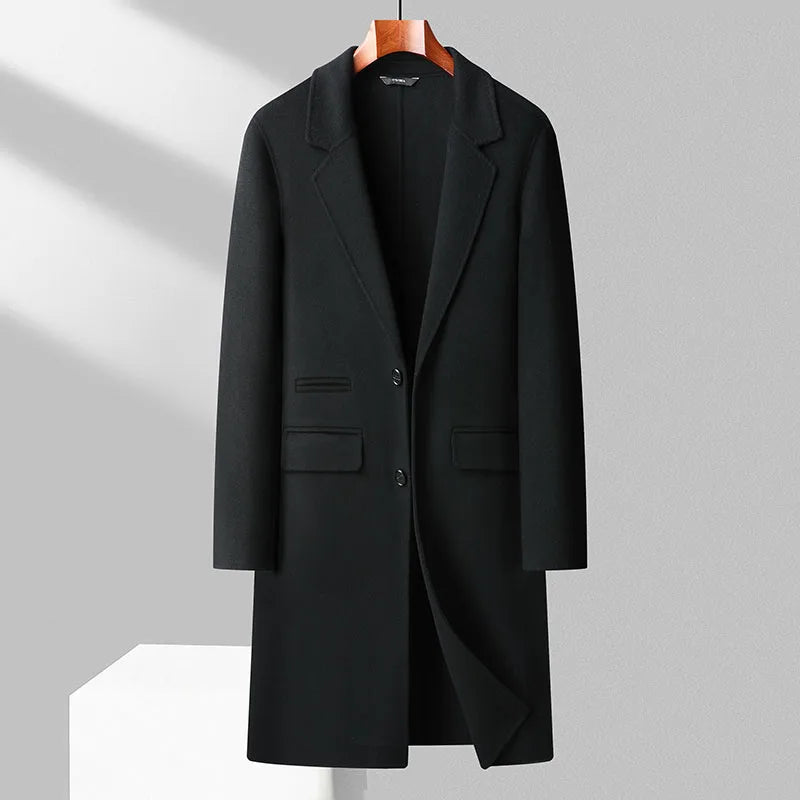 Black coat on a hanger against a gray background