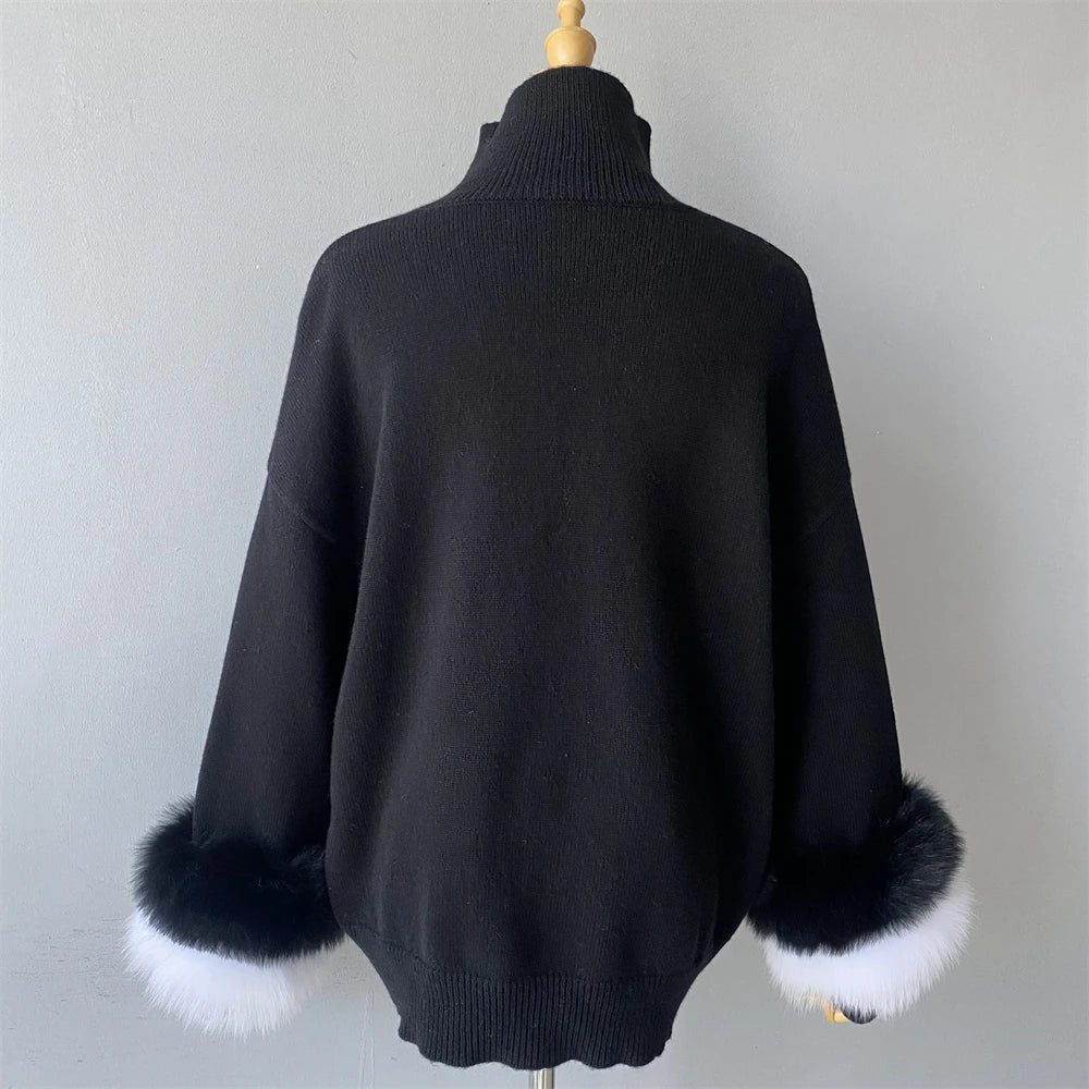 Black sweater with fur cuffs on a mannequin against a plain background