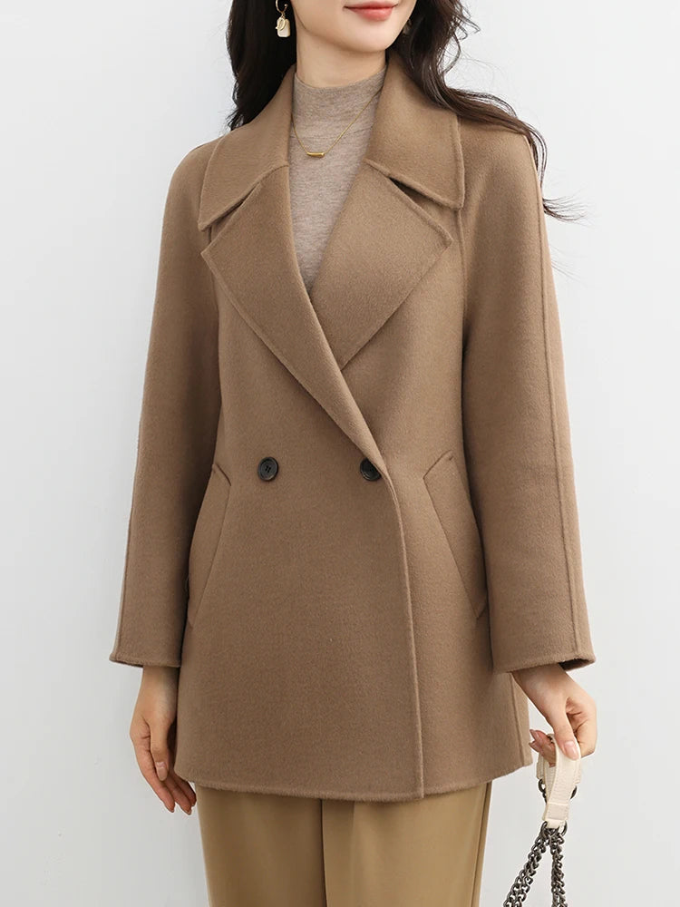Woman wearing a brown coat against a white background