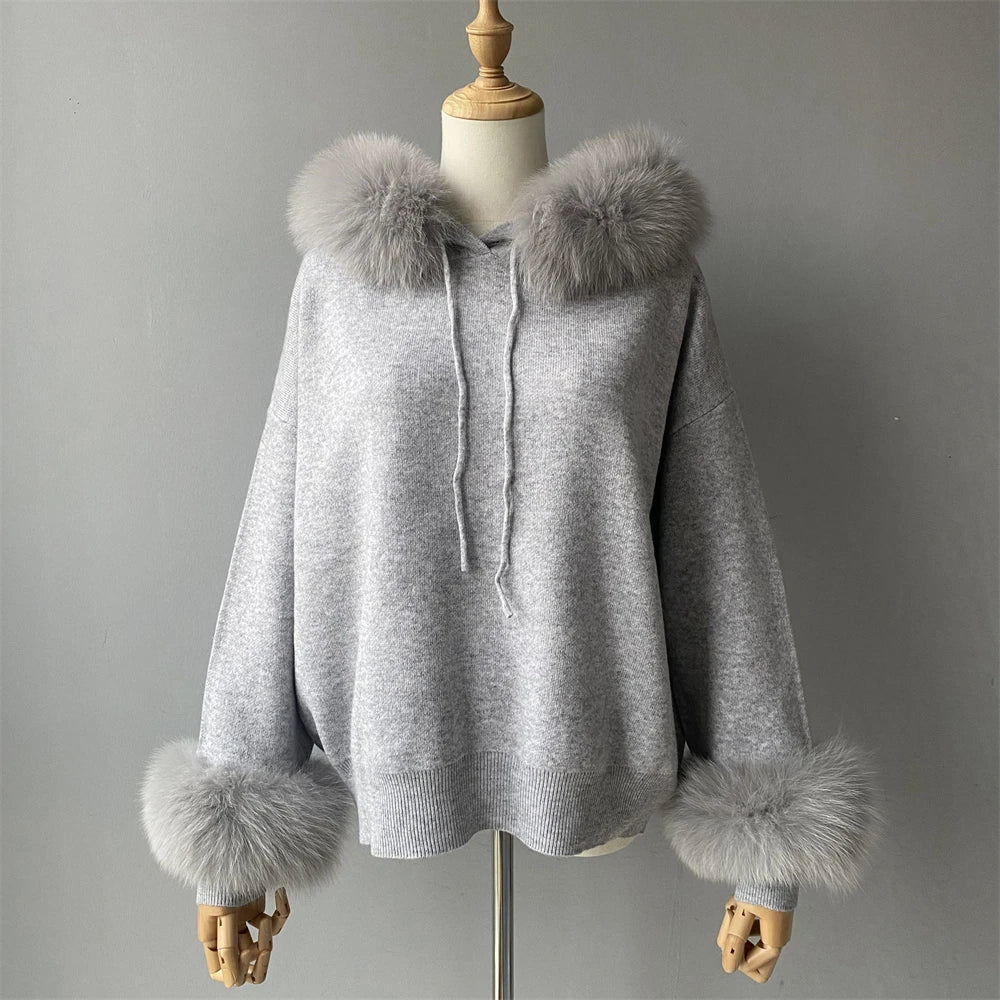Gray hooded sweater with fur trim on a mannequin against a gray background