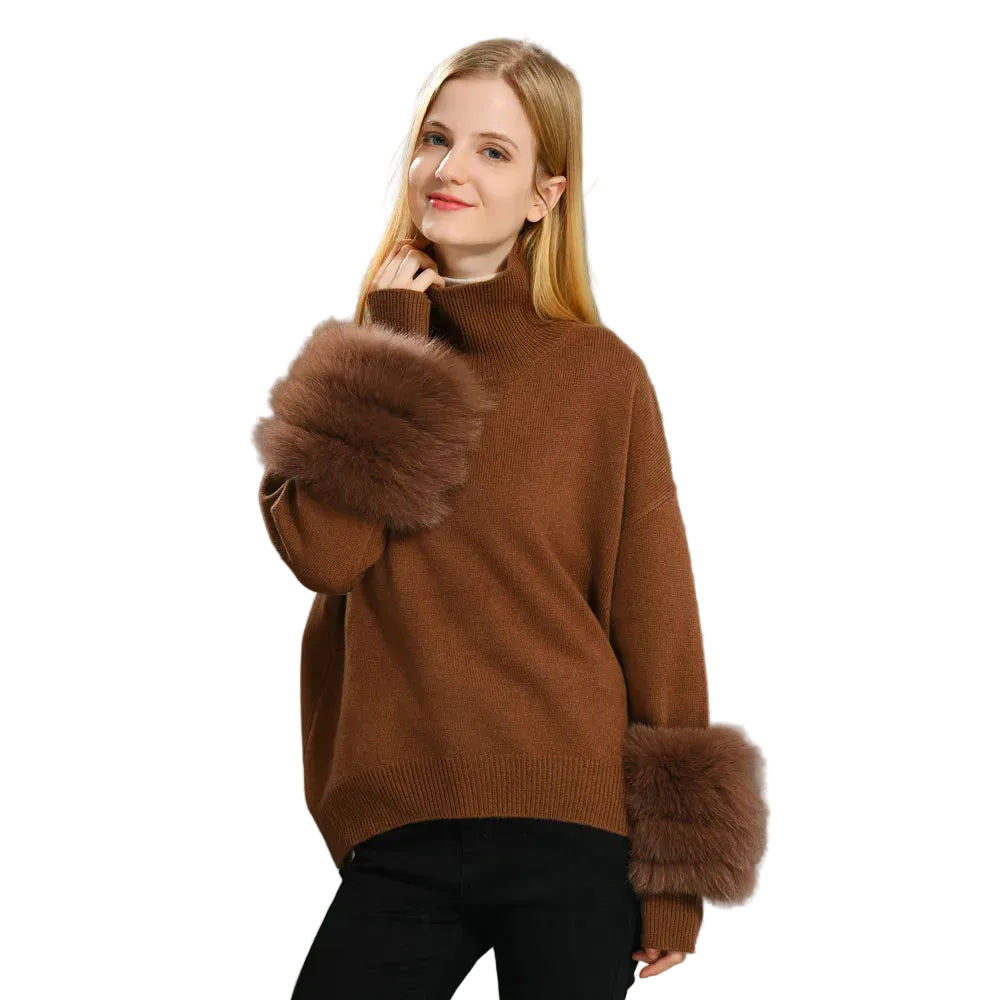Woman wearing a brown sweater with fur cuffs on a gray background