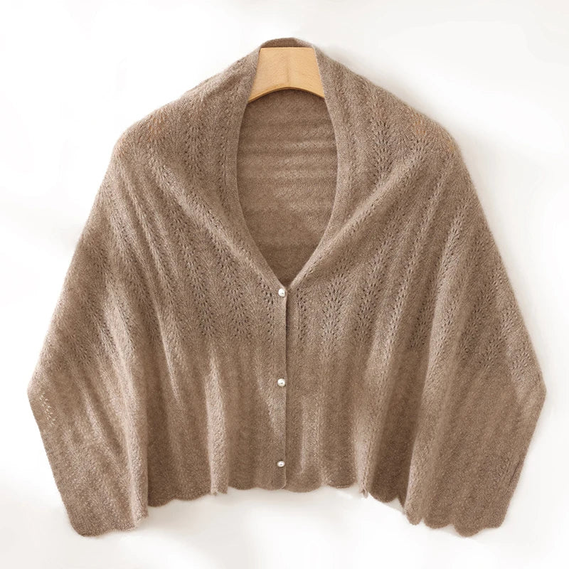 Brown knitted cardigan on a hanger against a white background