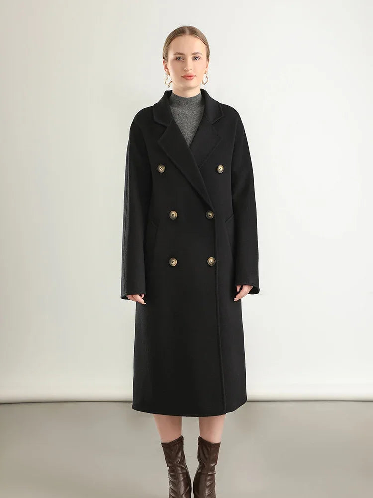 Woman wearing a black coat with gold buttons on a white background