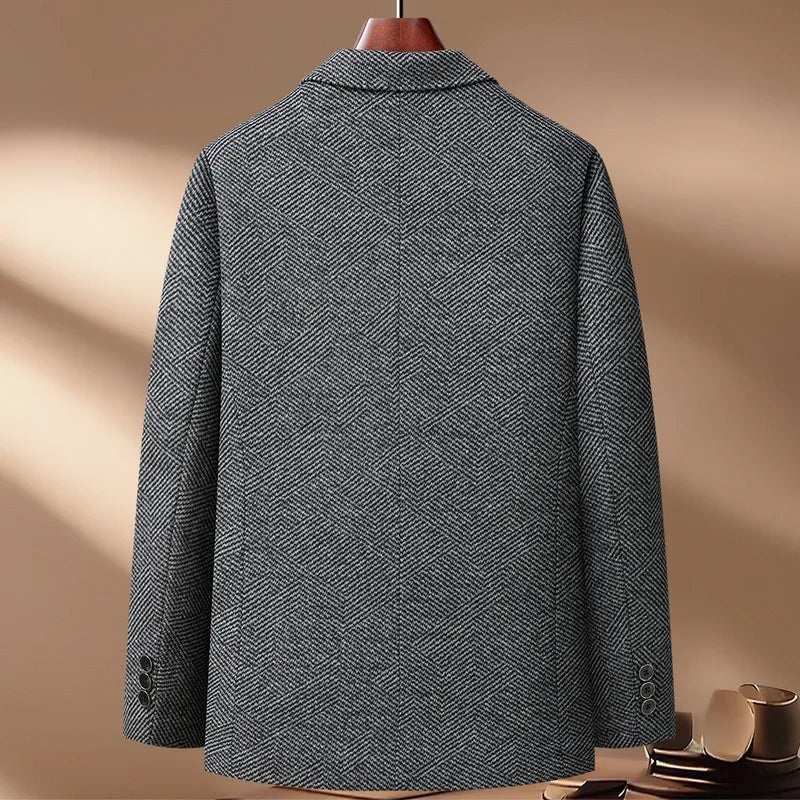 Gray textured coat on a hanger against a beige background