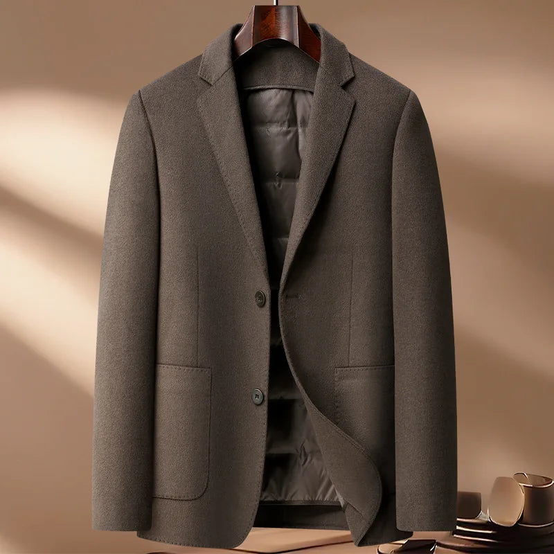 Gray blazer on a hanger against a beige background