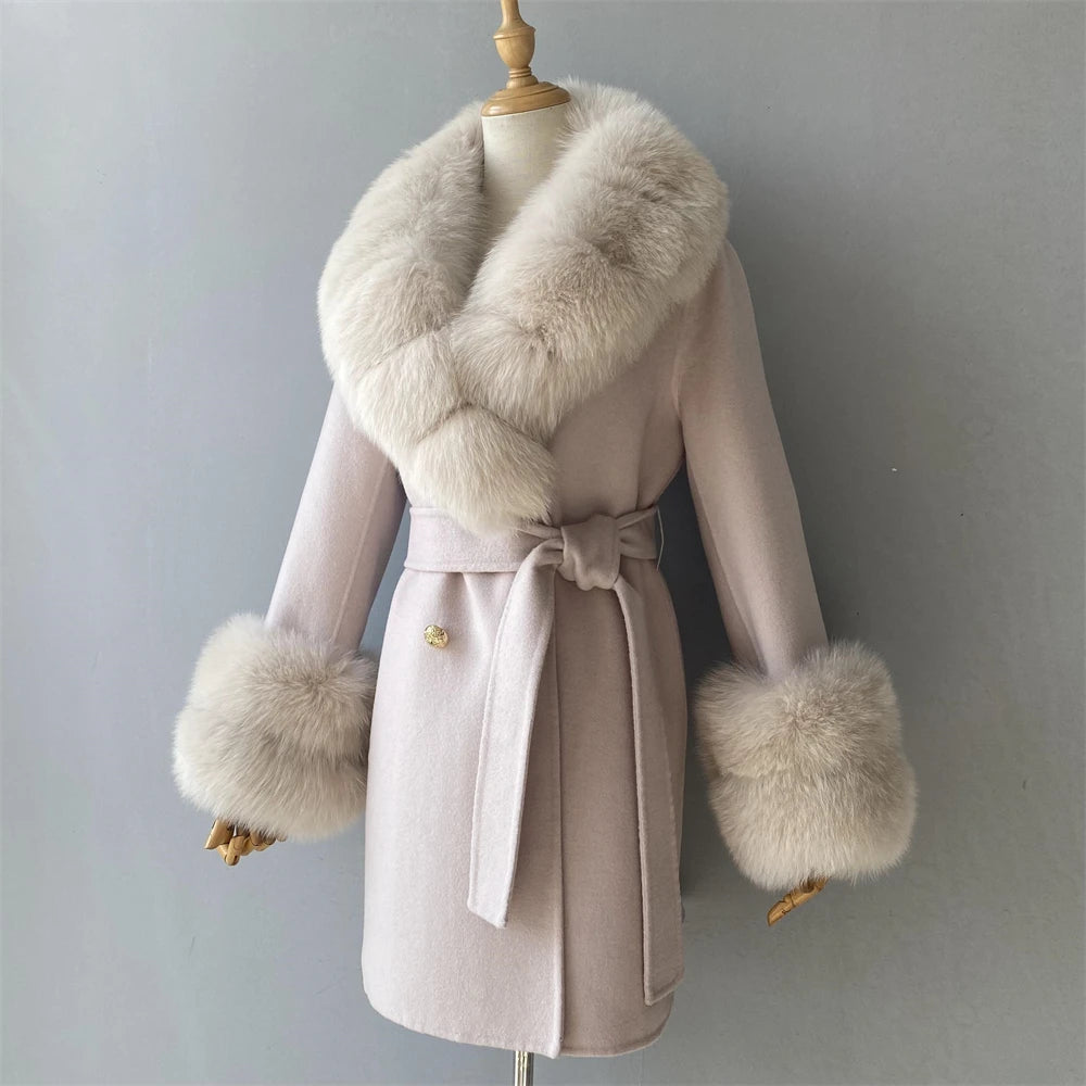 Pink coat with fur collar and cuffs on a mannequin against a gray background